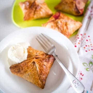apple and raspberry puff pastry pie in a bowl with vanilla icecream