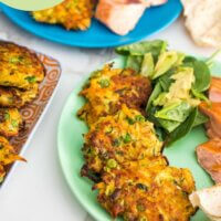 pinterest image for Zucchini, Carrot and Pea Fritters, showing fritters on a plate