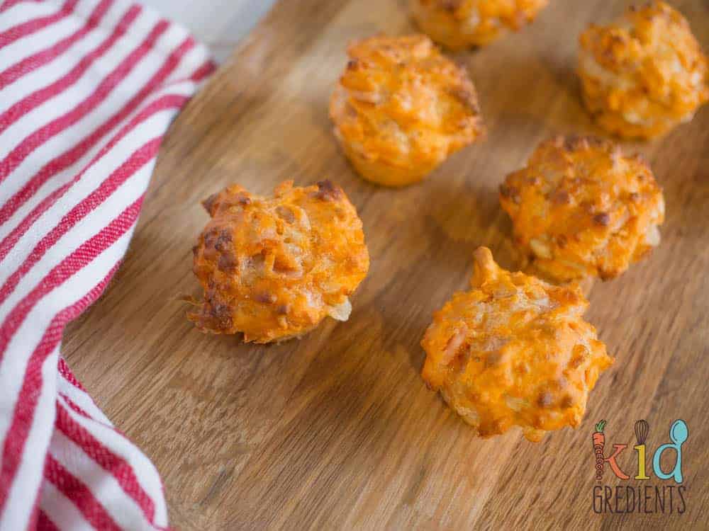Pizza mini muffins, perfect for the lunchbox and an awesome afternoon snack. Savoury with bacon and cheese, this yummy recipe freezes well and makes 24 mini muffins!