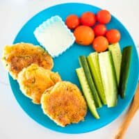 veggie nuggets on a plate with cucumber and tomatoes