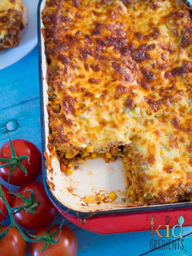 This easy bake mexican lasagna is awesome for filling the kids with veggies! Freezer friendly and super yummy.