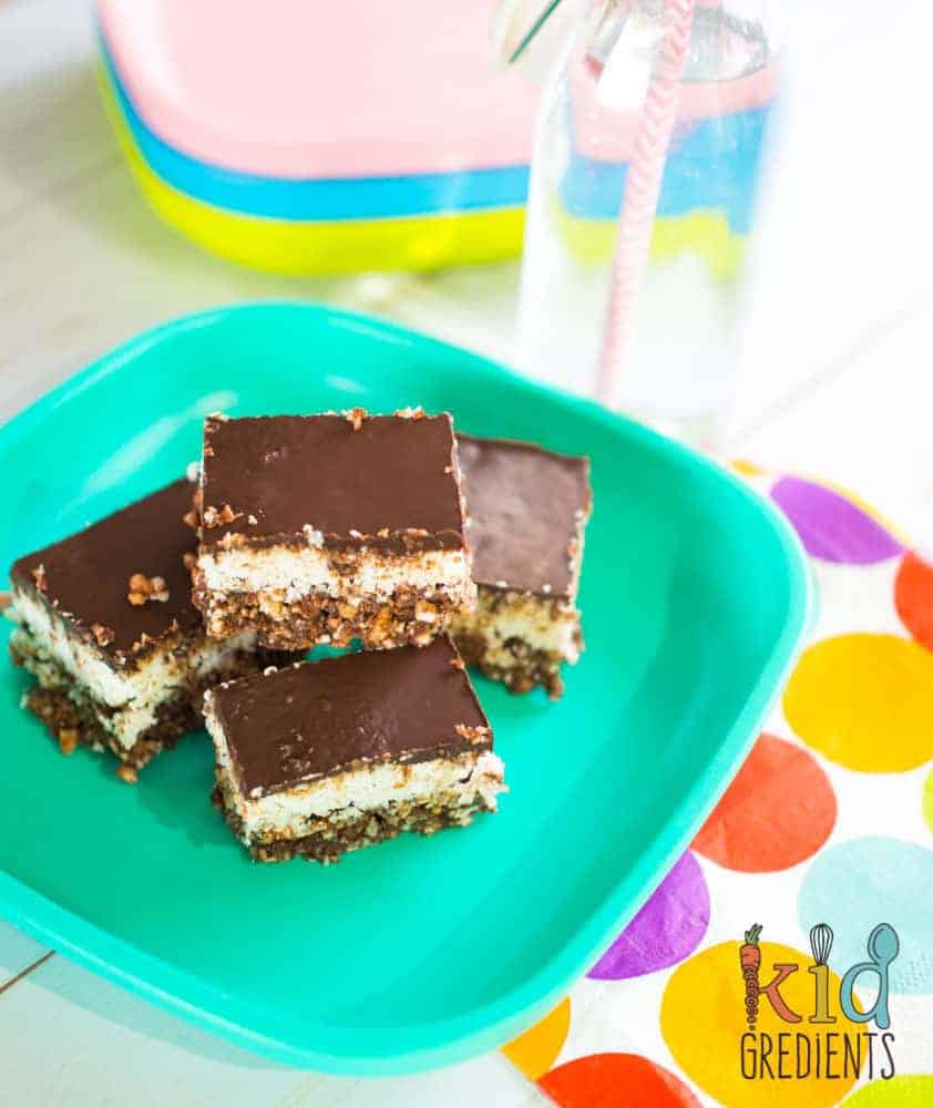 Healthy no bake choc bounty slice. So yummy, so easy to make, the perfect snack! No bake and toddler friendly- no nuts or honey! Kid friendly and freezer friendly. #recipe #kidsfood #partyfood #chocolate #healthykids #nobake #healthychocolate