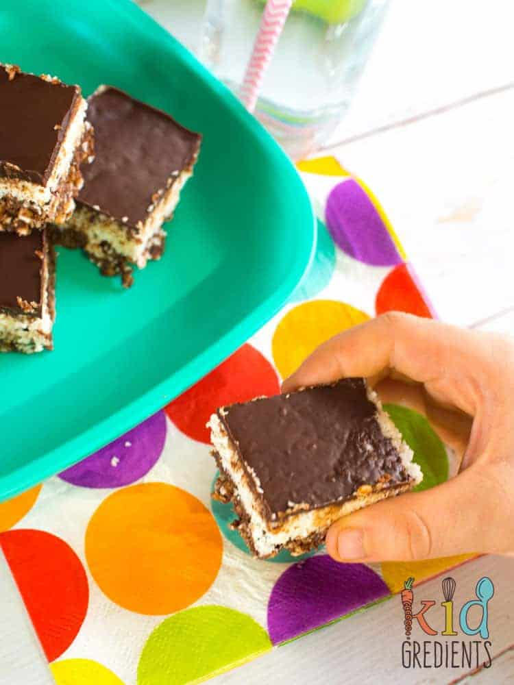 Healthy no bake choc bounty slice. So yummy, so easy to make, the perfect snack! No bake and toddler friendly- no nuts or honey! Kid friendly and freezer friendly. #recipe #kidsfood #partyfood #chocolate #healthykids #nobake #healthychocolate