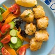 salmon bites on a plate with salad