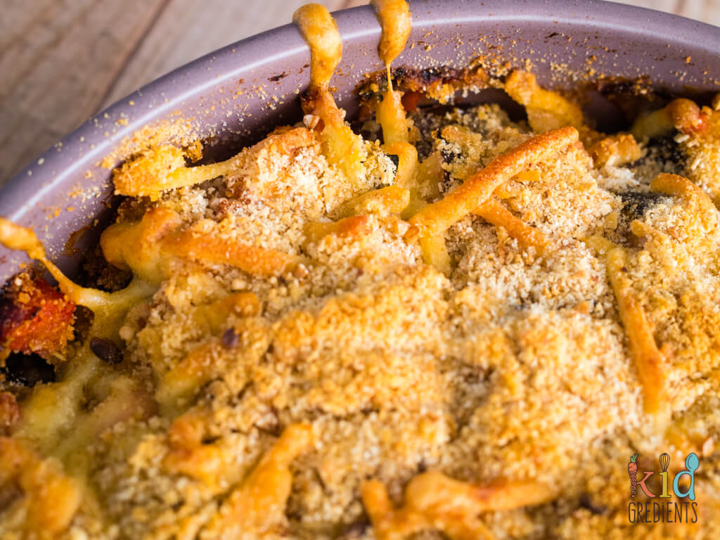 crunchy cheese and breadcrumbs on the edge of the mediterranean veggie bake