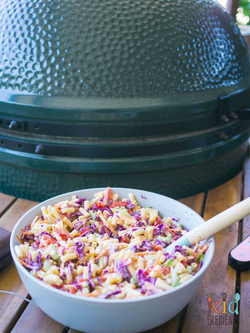 pasta salad on a table in front of a big green egg bbq
