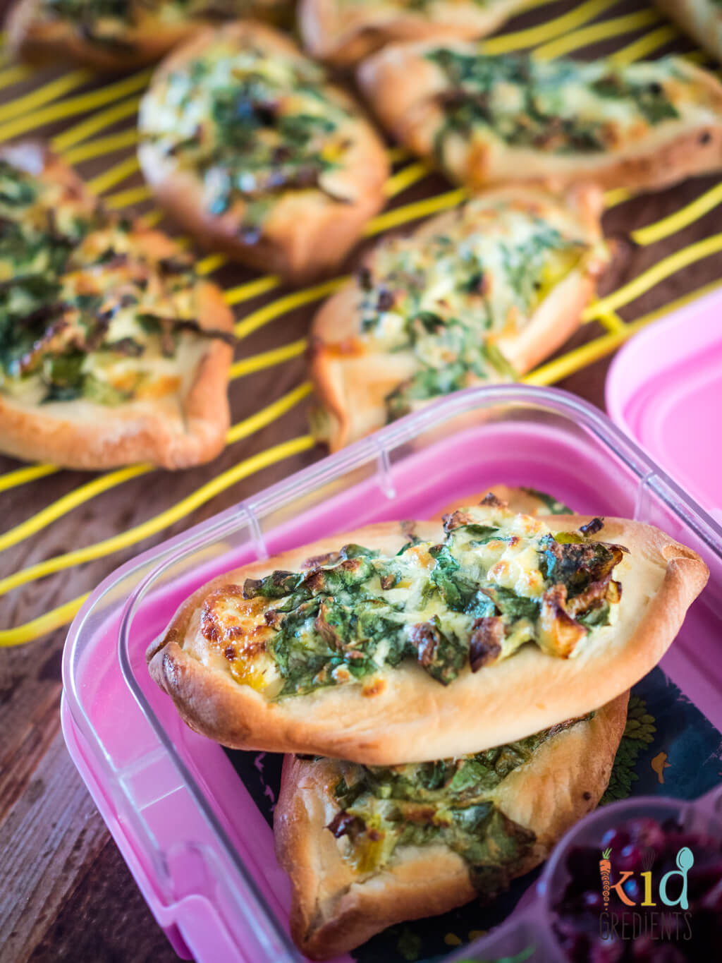cheese and spinach pides, in a lunchbox and ready to go!