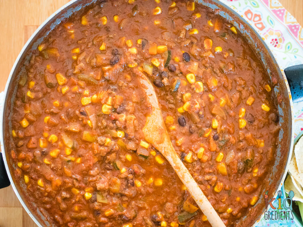 chilli con carne close up with the spoon in the pot