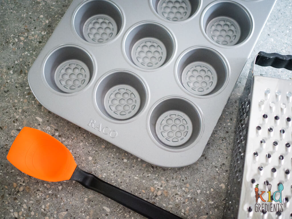 muffin pan, grater and silicone spatula