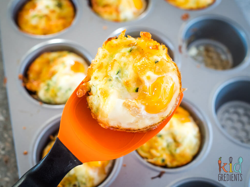 egg cup on a silicone spatula, as it's being removed from the muffin pan