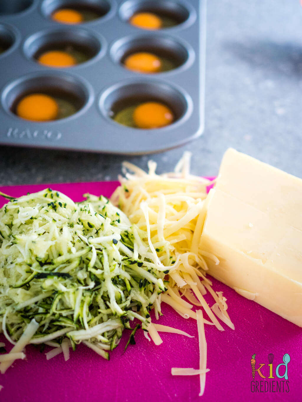 zucchini and cheese grated on a chopping board