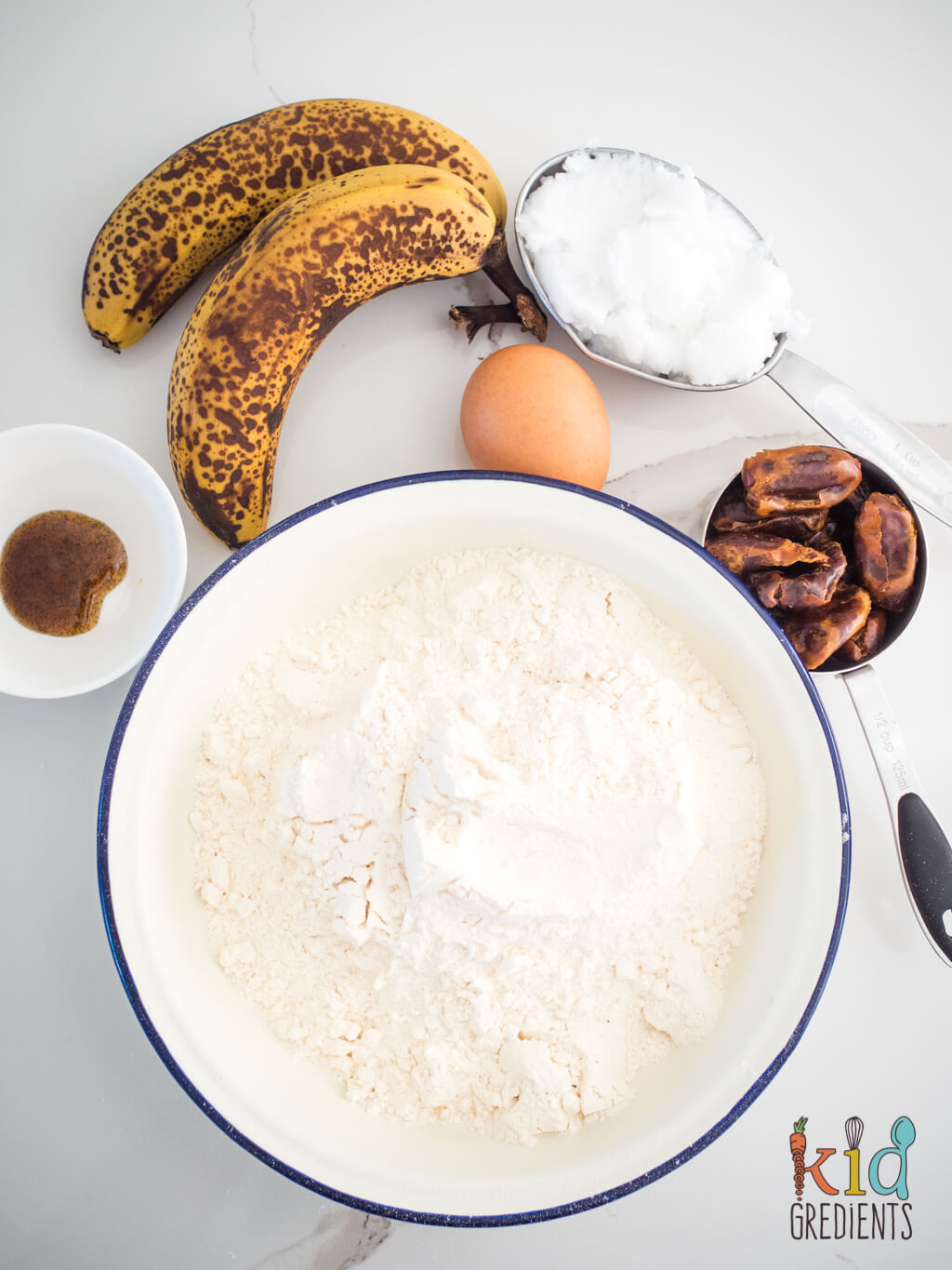 ingredients shot: self raising flour, dates, bananas, egg, coconut oil and vanilla paste