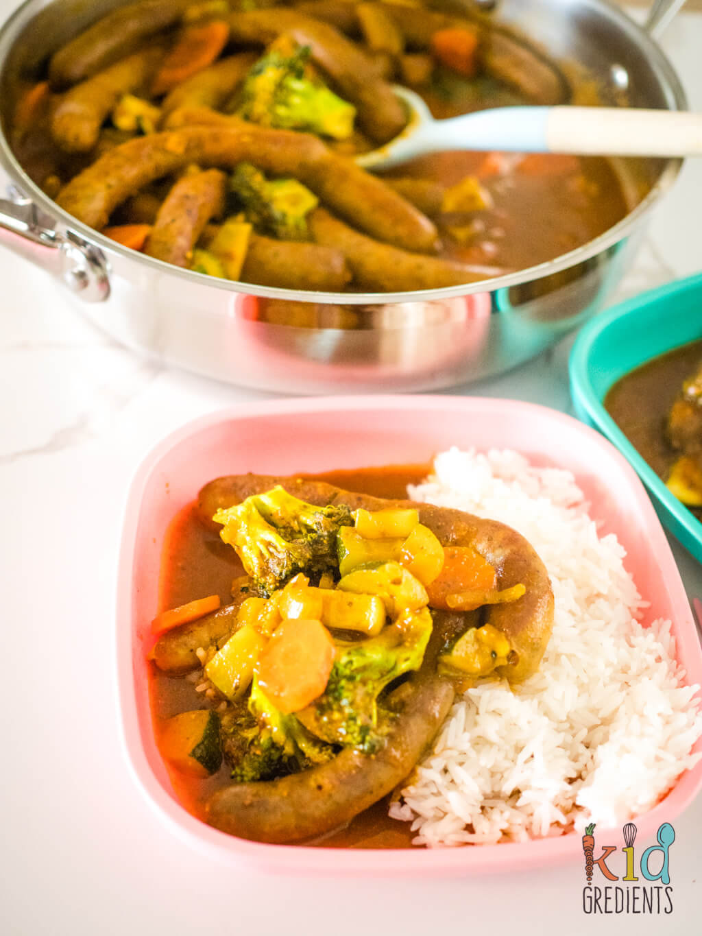 curried sausages on a pink kids plate
