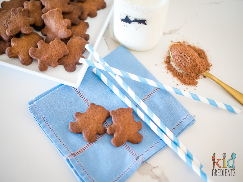 two teddy biscuits on a cloth napkin with blue and white paper straws
