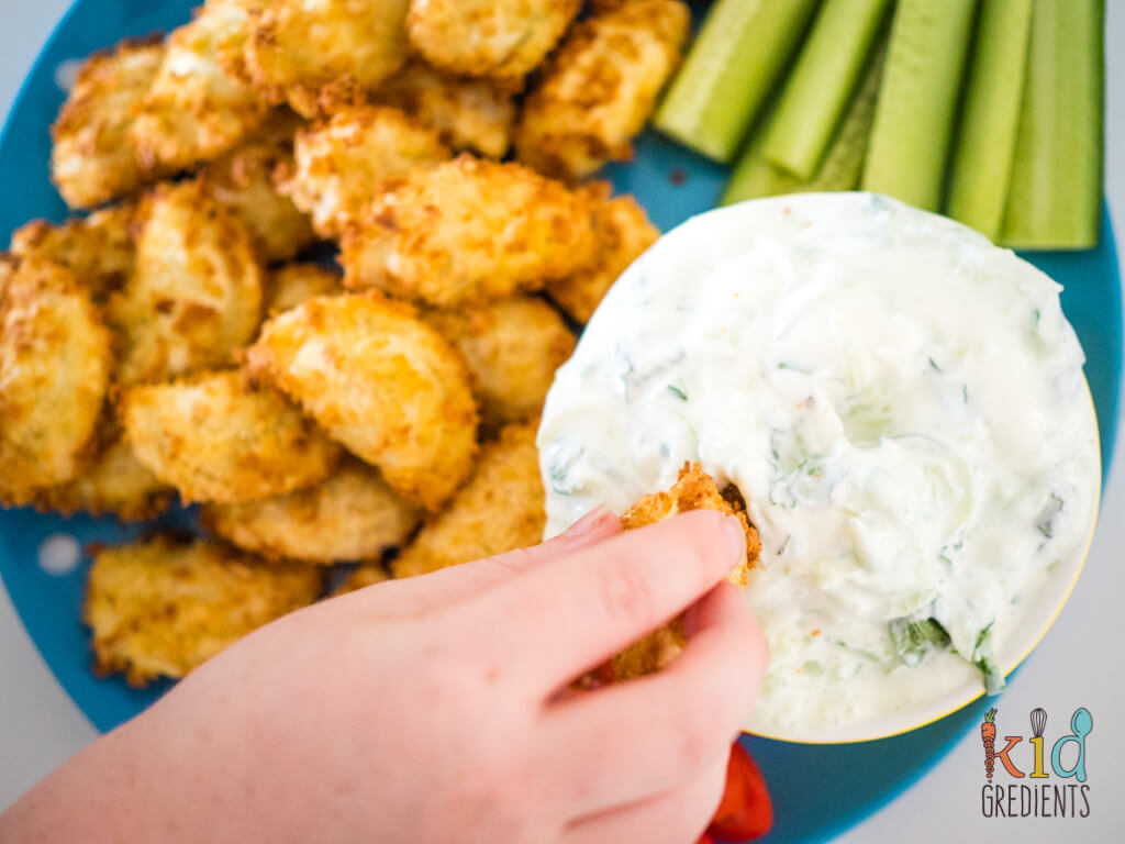 tzatziki with a kid dipping into it