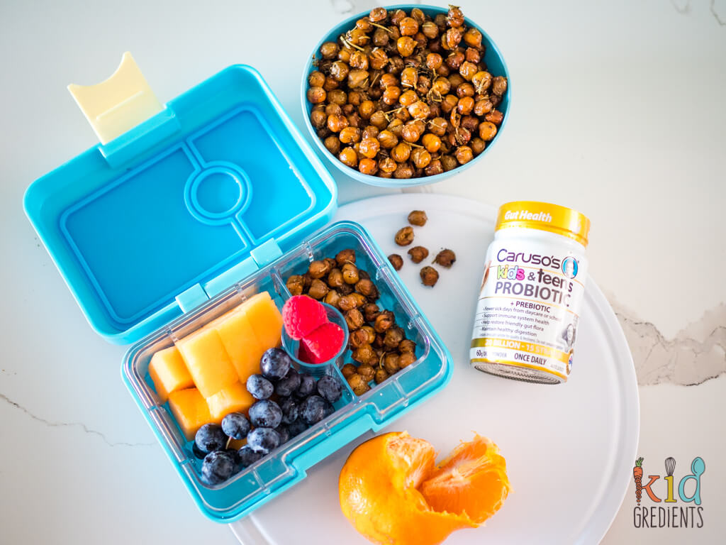 chickpeas in a lunchbox, in a bowl next to a bottle of Caruso's kids and teens probiotics