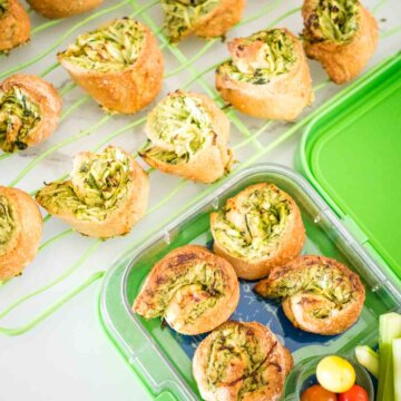 spinach pinwheels, in a lun chbox and on a wire cooling rack