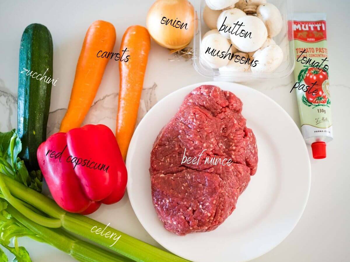 ingredients for beef mince tacos: beef mince, carrots, capsicum, zucchini, celery, button mushrooms, onion and tomato paste