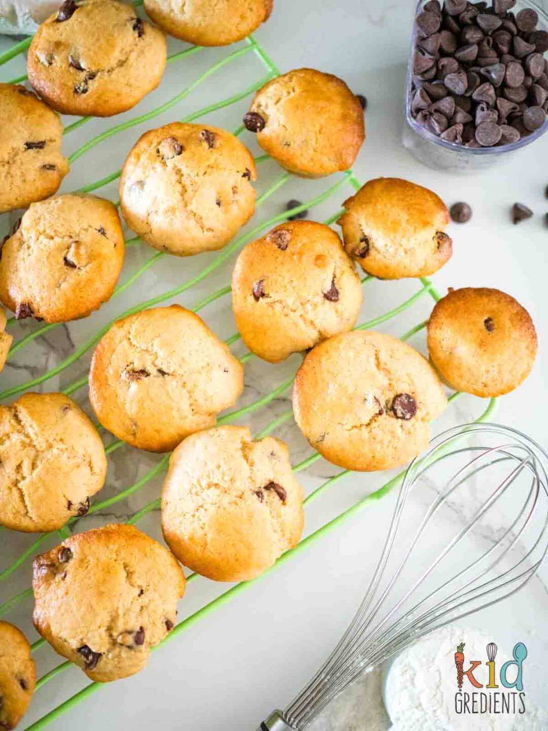 choc chip mini muffins on a tray with a whisk