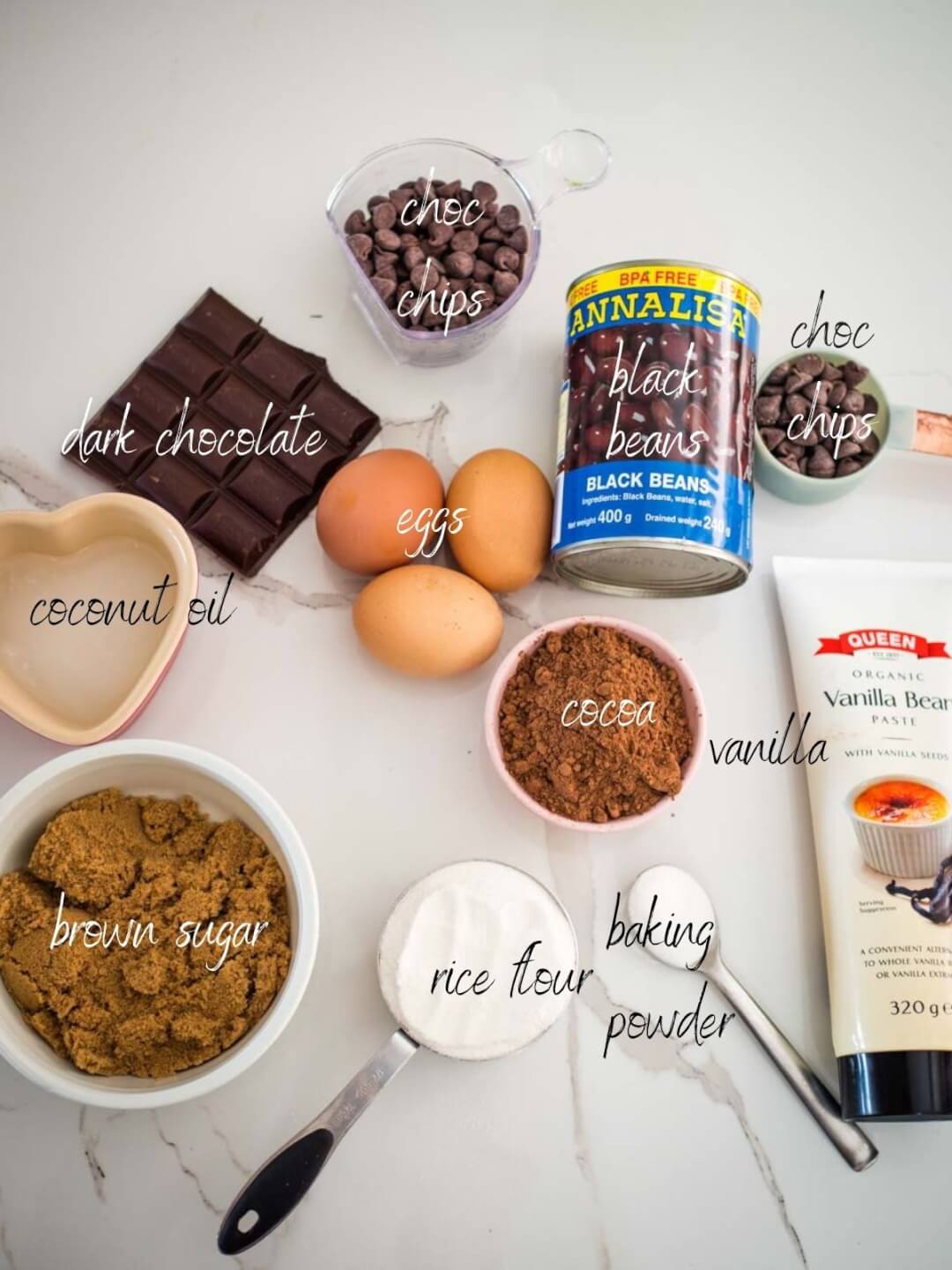 ingredients for chocolate brownies: chocolate chips, chocolate, cocoa, rice flour, black beans, eggs, vanilla, baking powder, brown sugar coconut oil