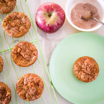 apple zucchini muffins on a plate and cooling rack