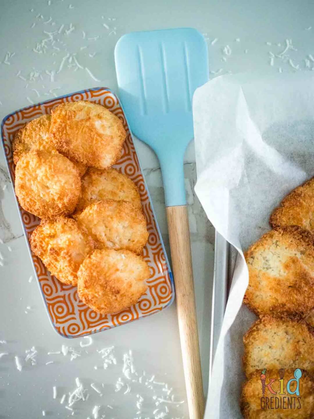 Coconut macaroons on a plate. Blue spatula