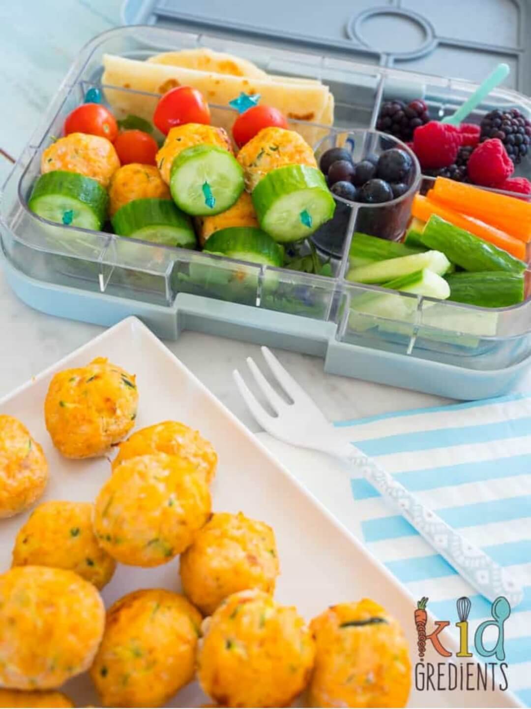 Salmon and Veggie balls on a plate and in a lunchbox.