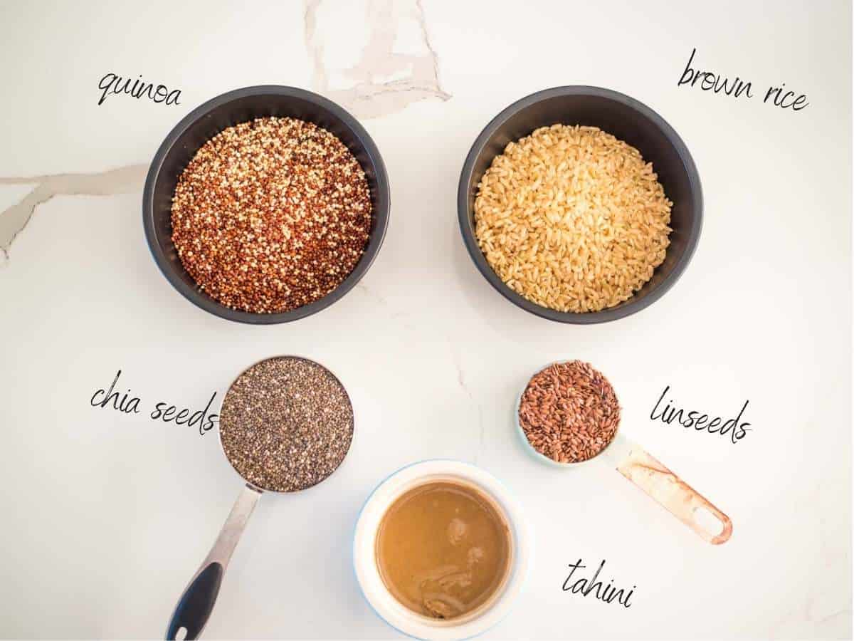 ingredients for easy homemade rice crackers: quinoa, brown rice, chia seeds, linseeds, tahini