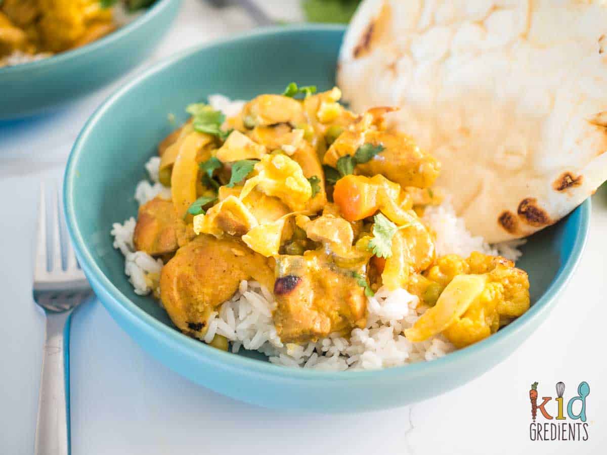 Mango Chicken Curry in a bowl with rice and a naan bread