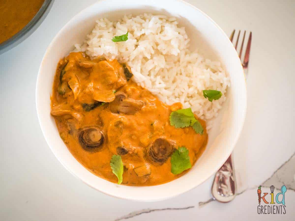 creamy mushroom curry in a bowl with rice