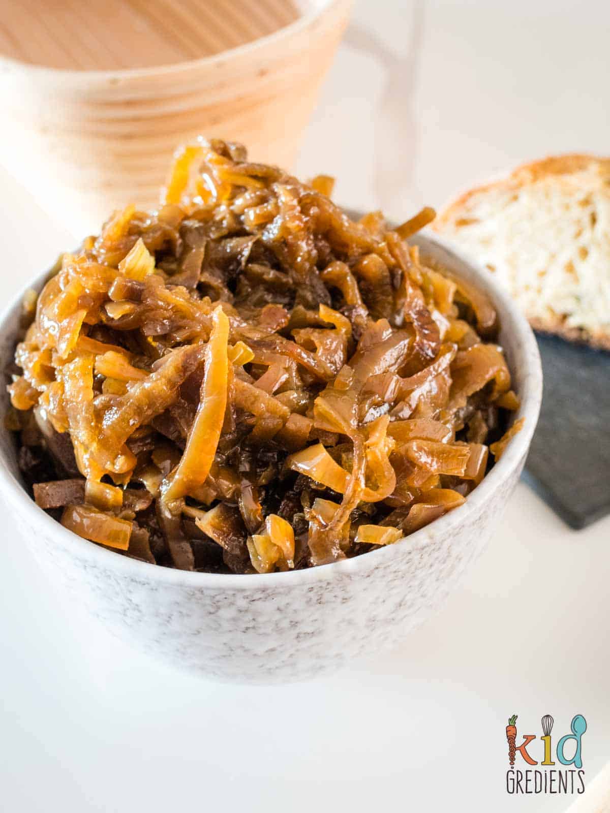 caramelised onions in a bowl with sourdough behind