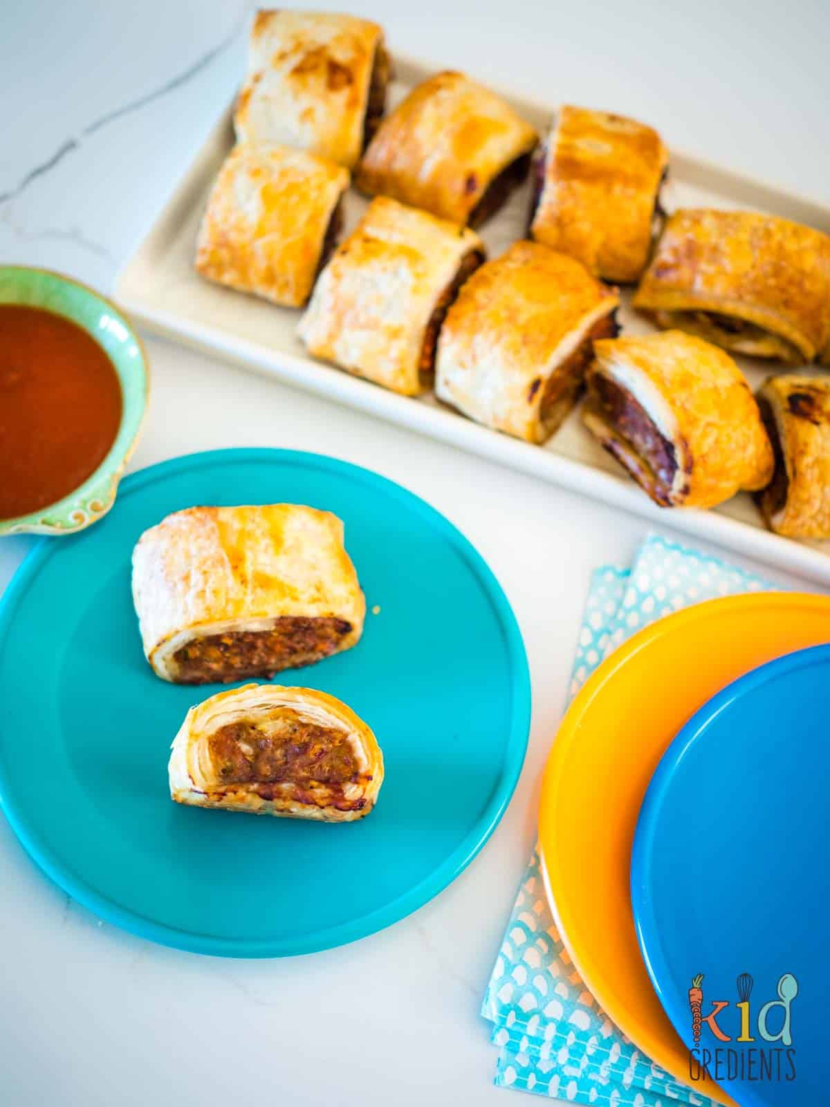 turkey sausage rolls on a plate and on a tray