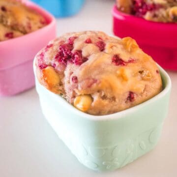 baked raspberry and white chocolate muffin in a silicone snack cup