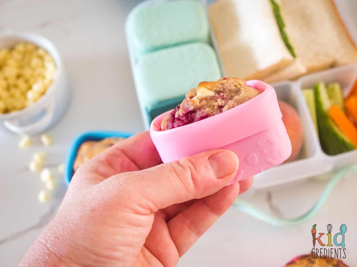 raspberry and white chocolate muffin in a silicone snack cup over a lunchbox
