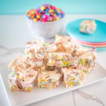white chocolate rocky road on a plate with smarties behind it