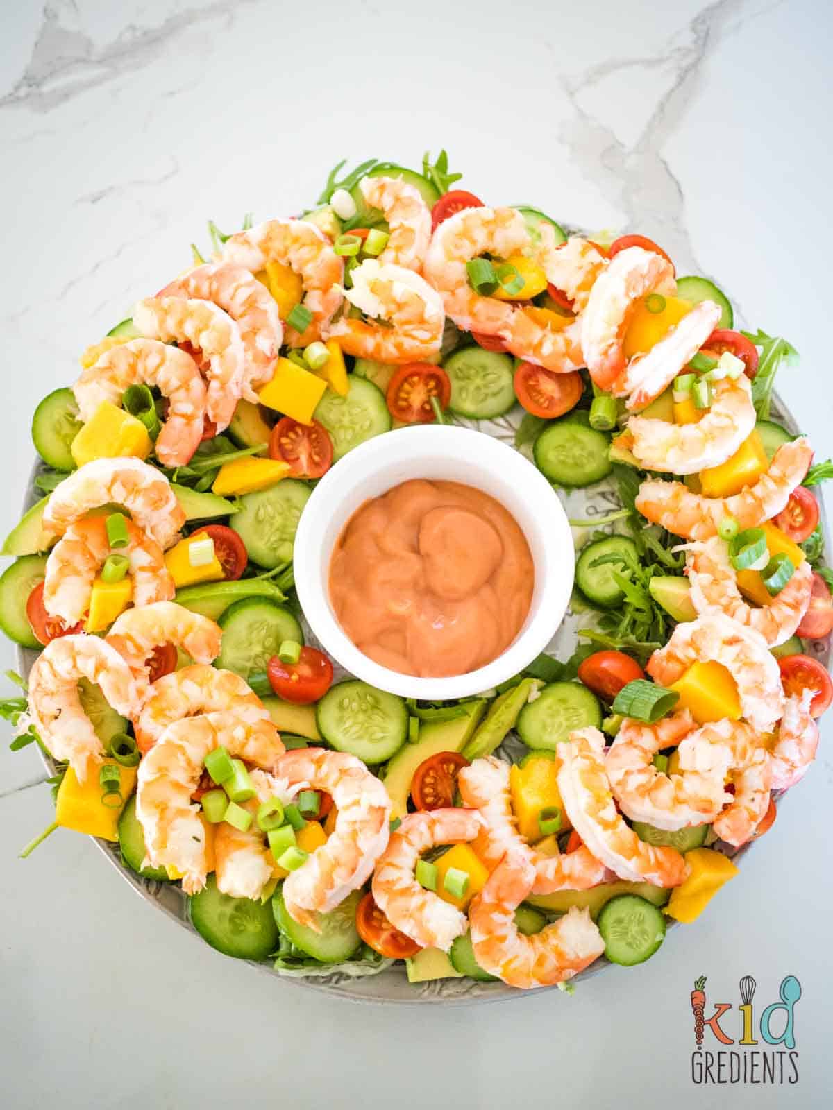 prawn and mango salad as a wreath on a plate with seafood sauce in the middle