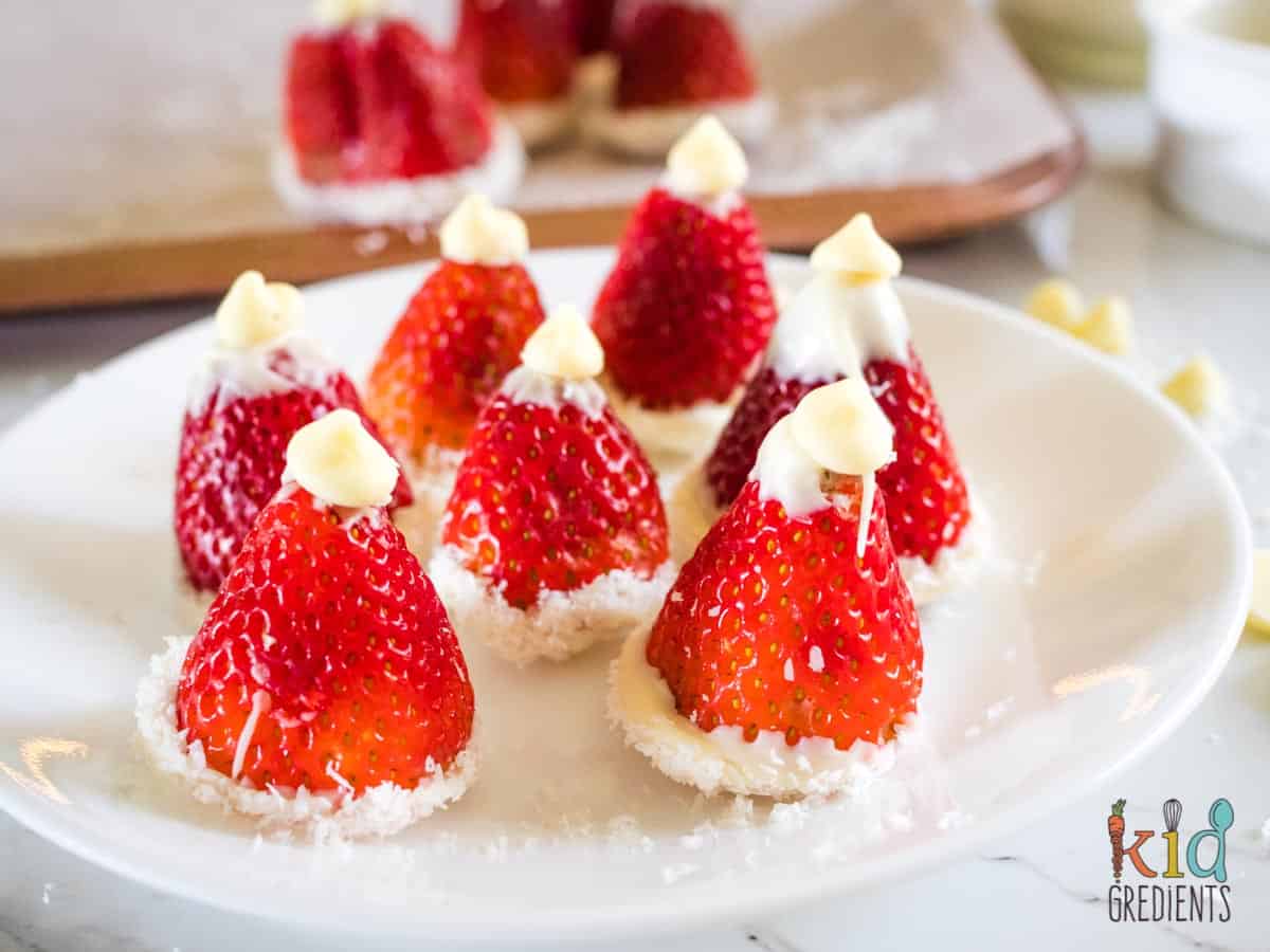 strawberry santa hats on a plate
