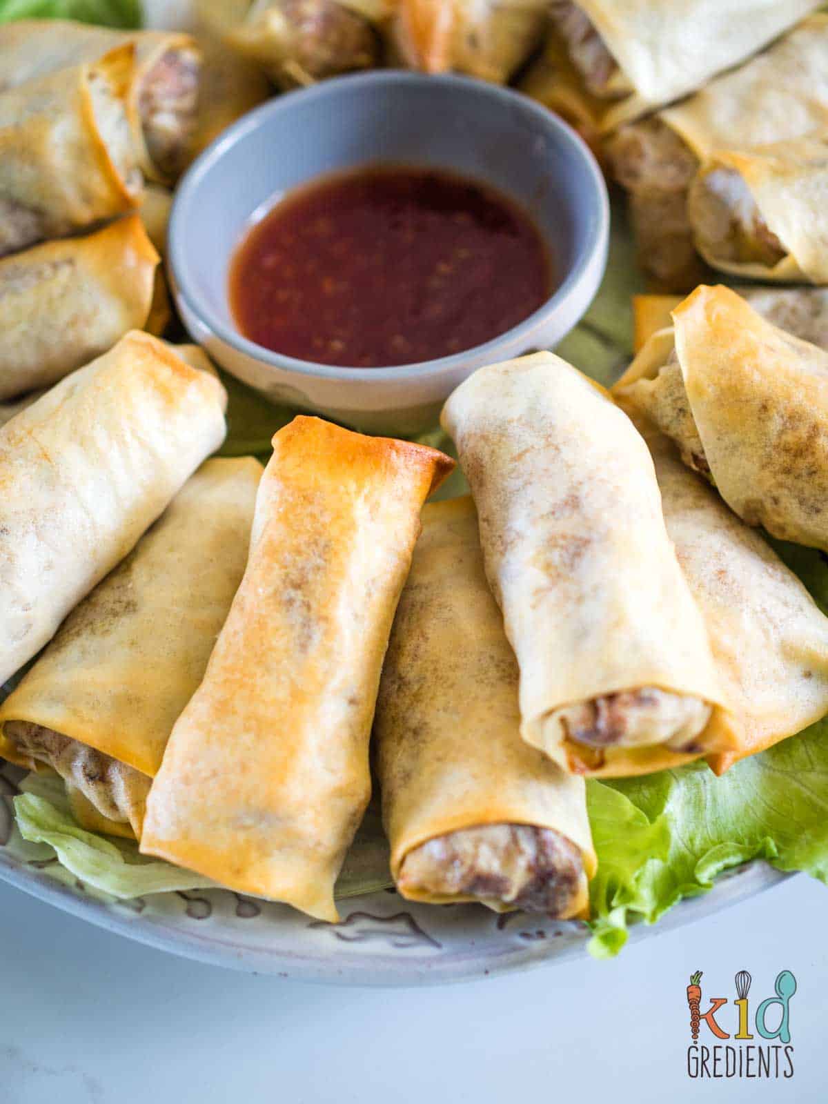 duck spring rolls on a platter with sweet chilli  sauce