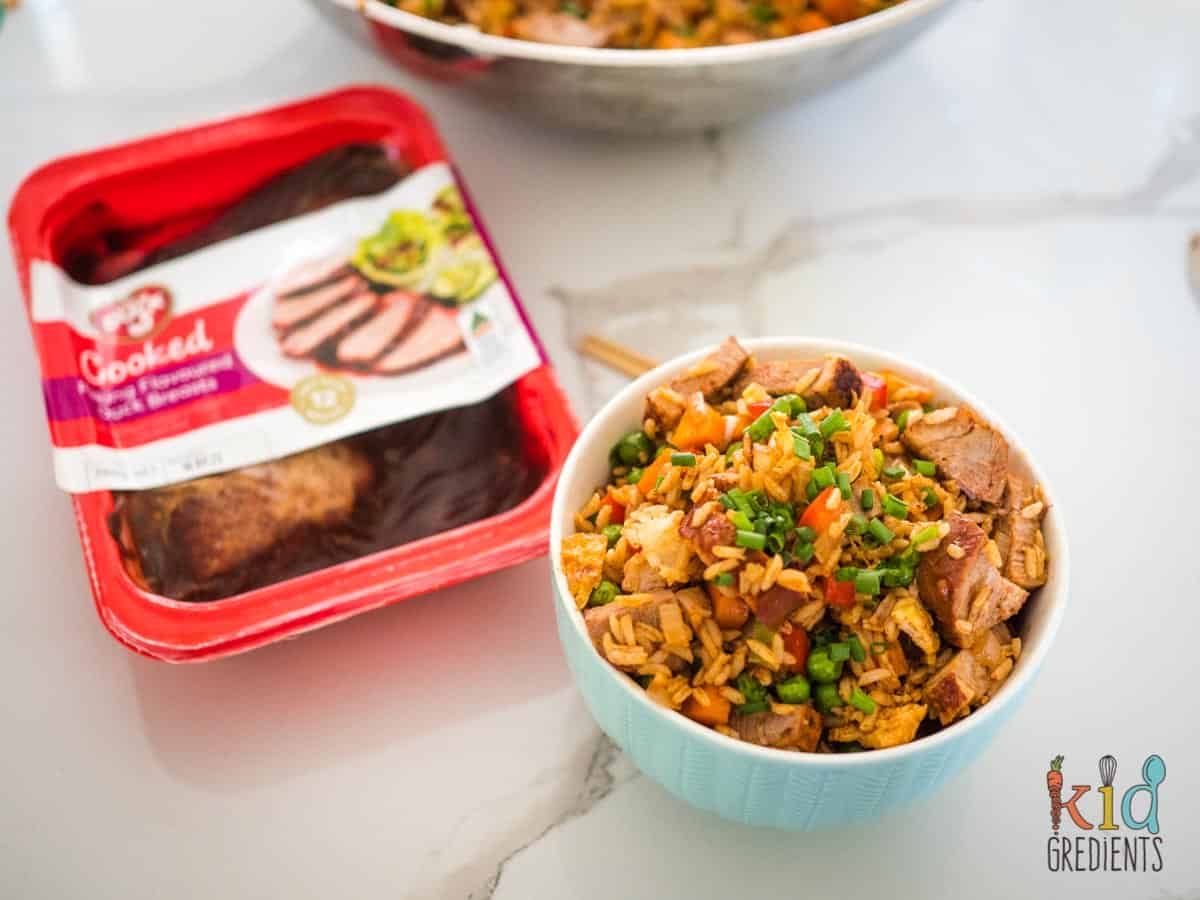 duck fried rice in a bowl next to a pack of peking flavoured duck breasts