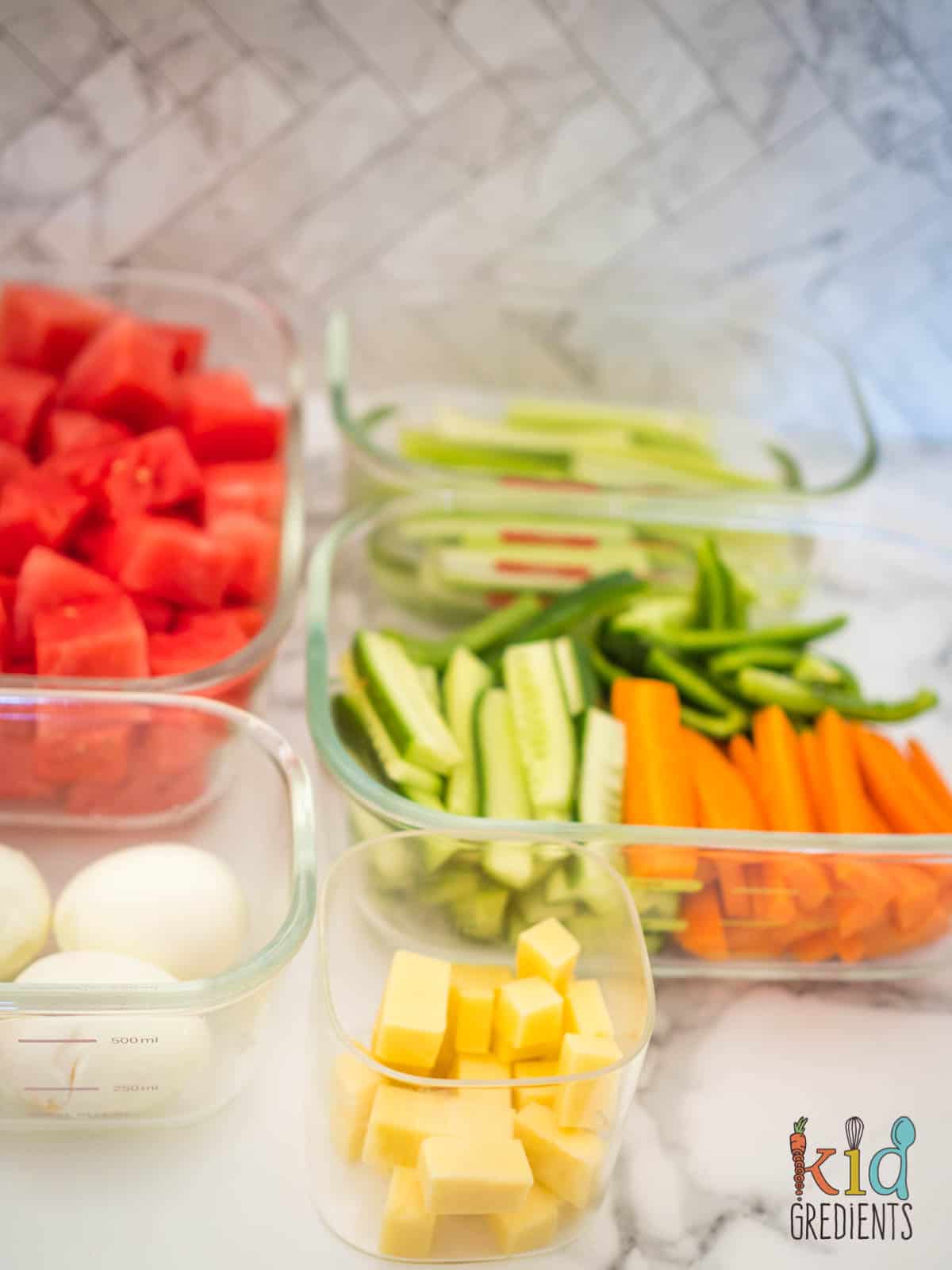 meal prepped carrots, cucumbers, watermelon, eggs and cheese